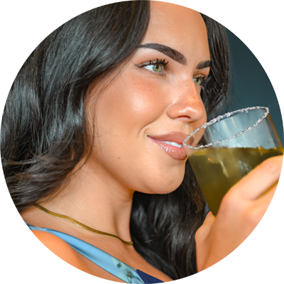 Woman holding a glass of margarita with a white background